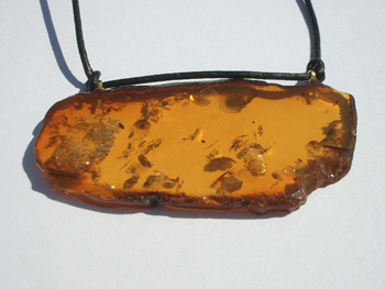 Flat fre form amber penfant - cognac color - almost transparent