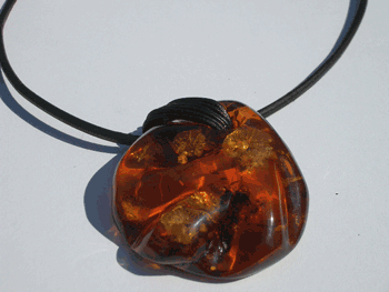 Front drilled cognac color free form Baltic amber pendant on leather cord / string. Very beautiful amber pendant